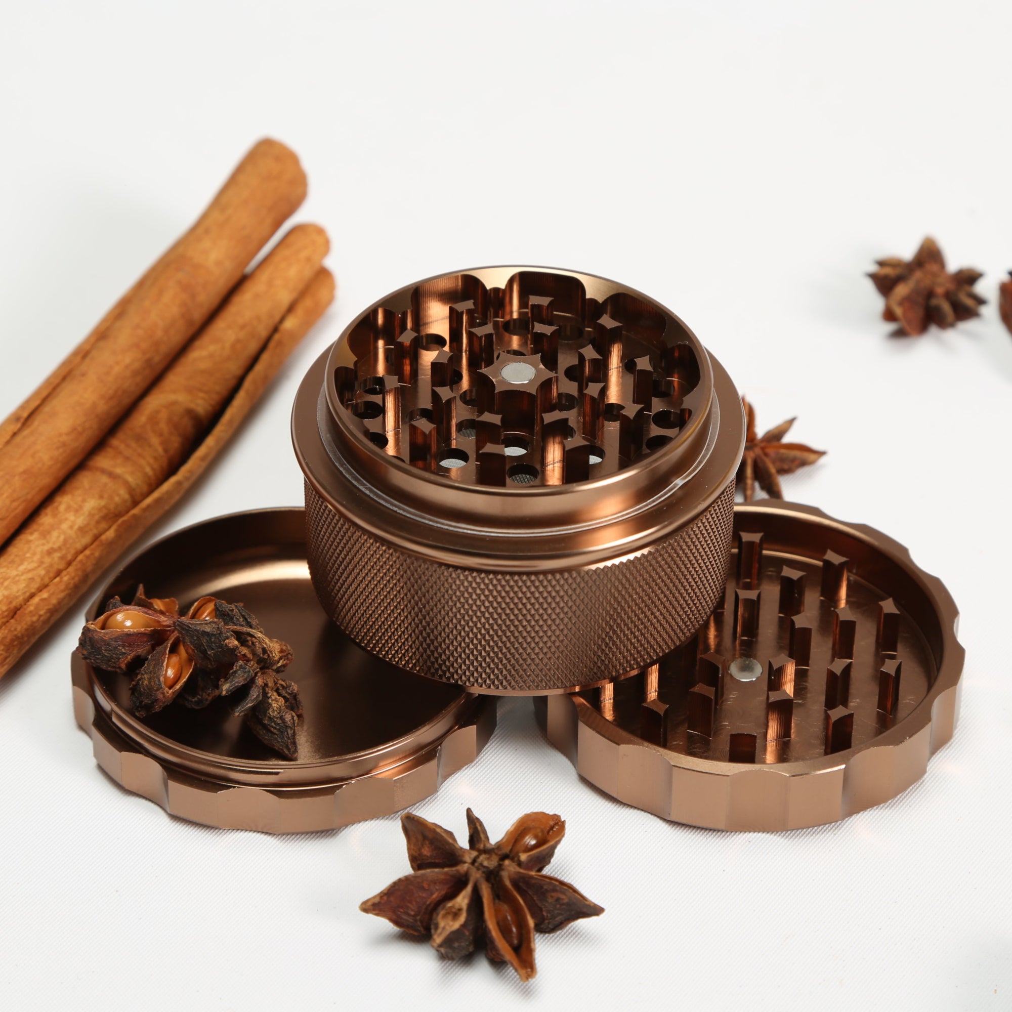 brown herb grinder with cinnamon sticks and star anise