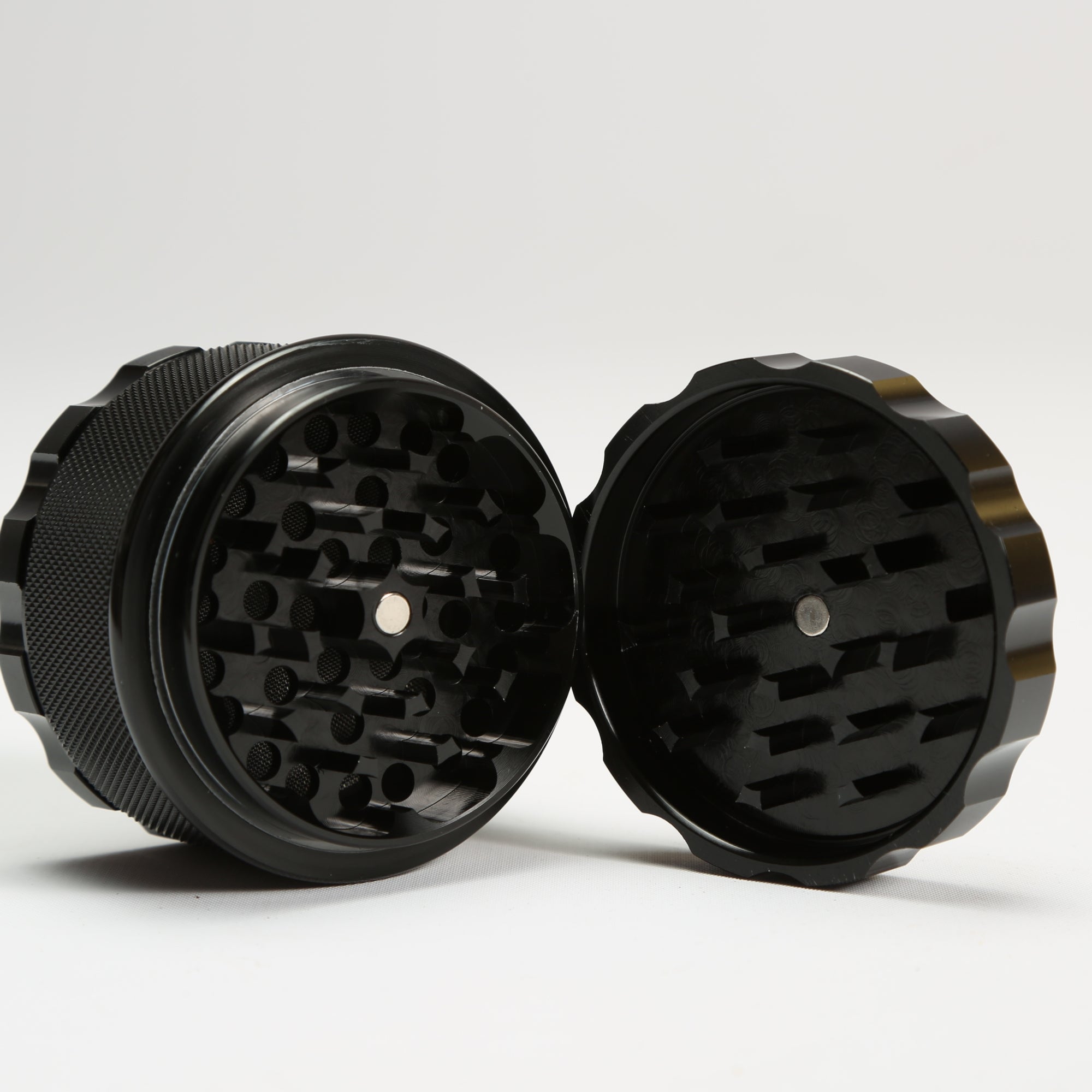 Black metal grinder on a white background