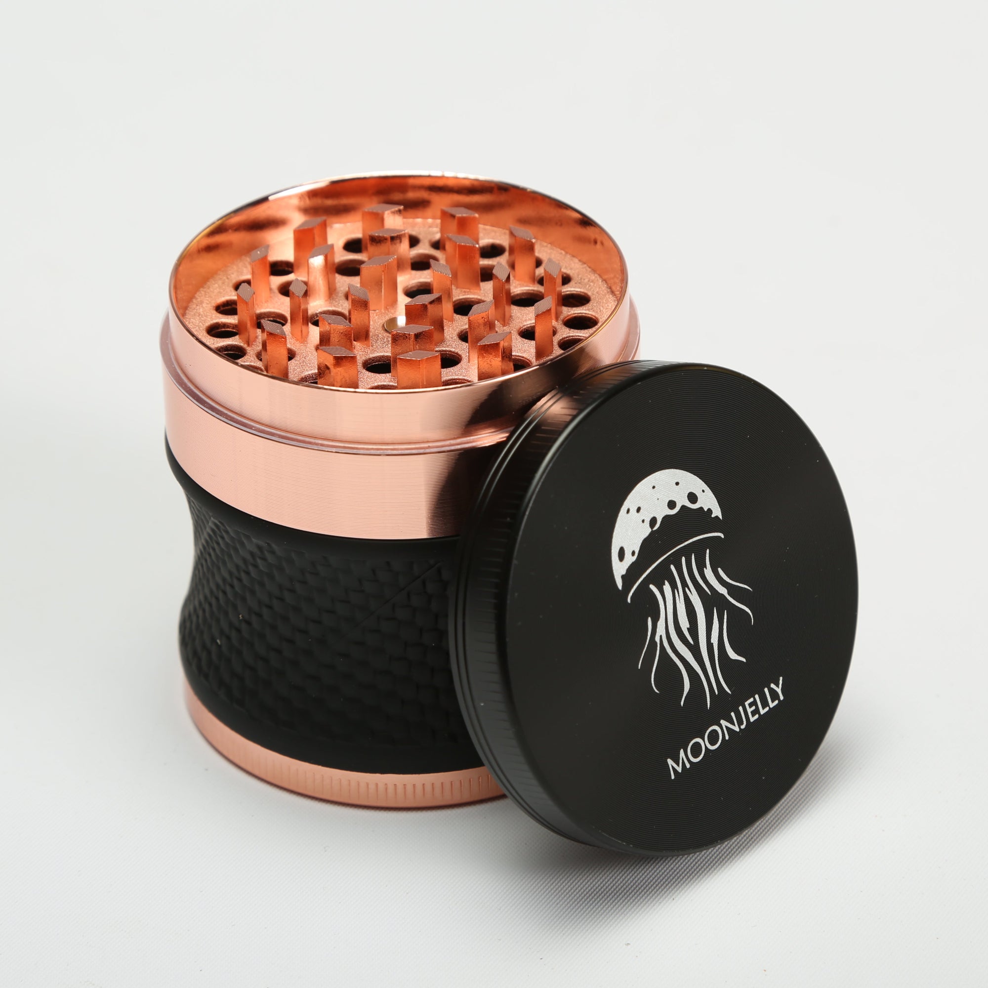 Rose gold and black grinder with &