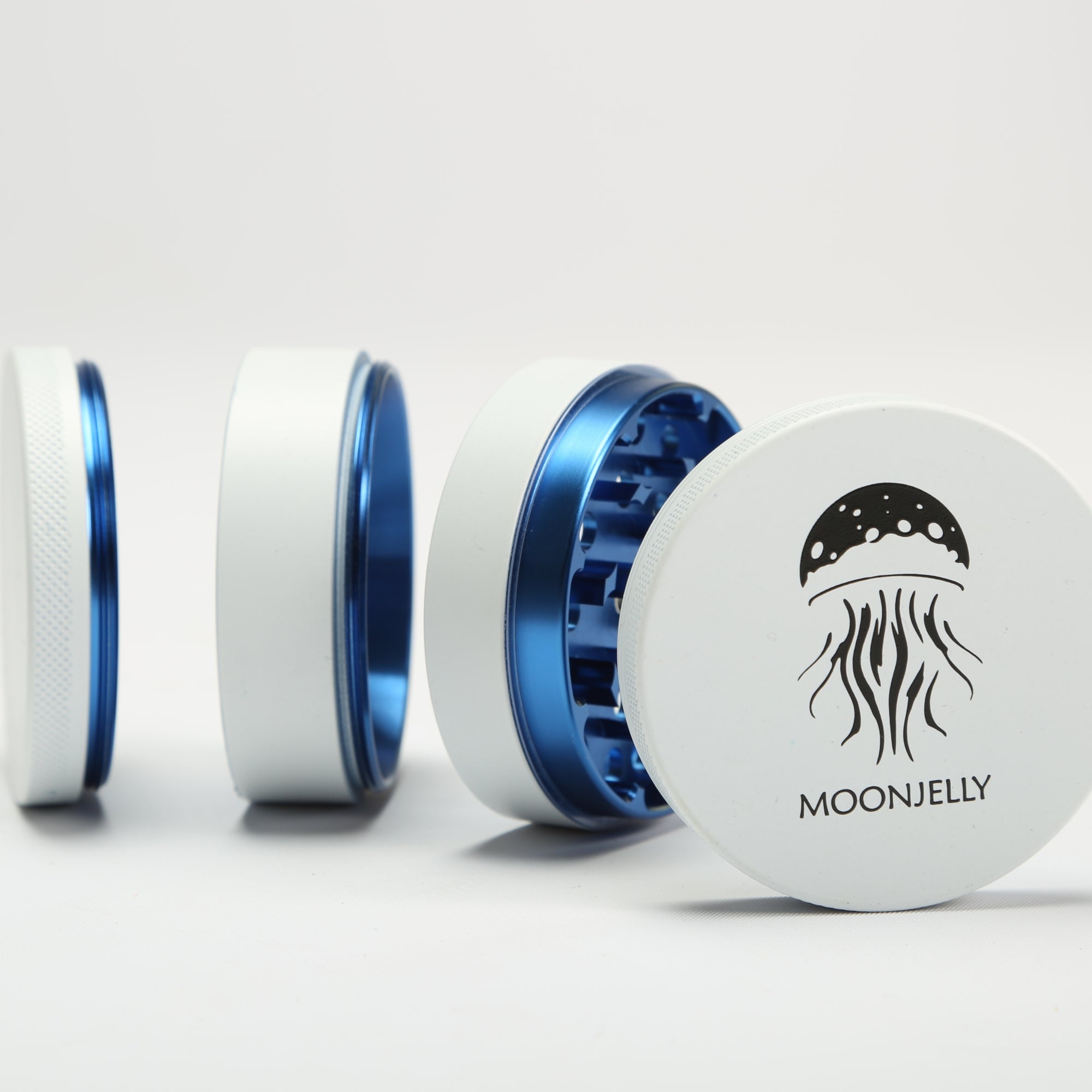 White and blue herb grinder with 'Moonjelly' branding on a white background #color_white-blue