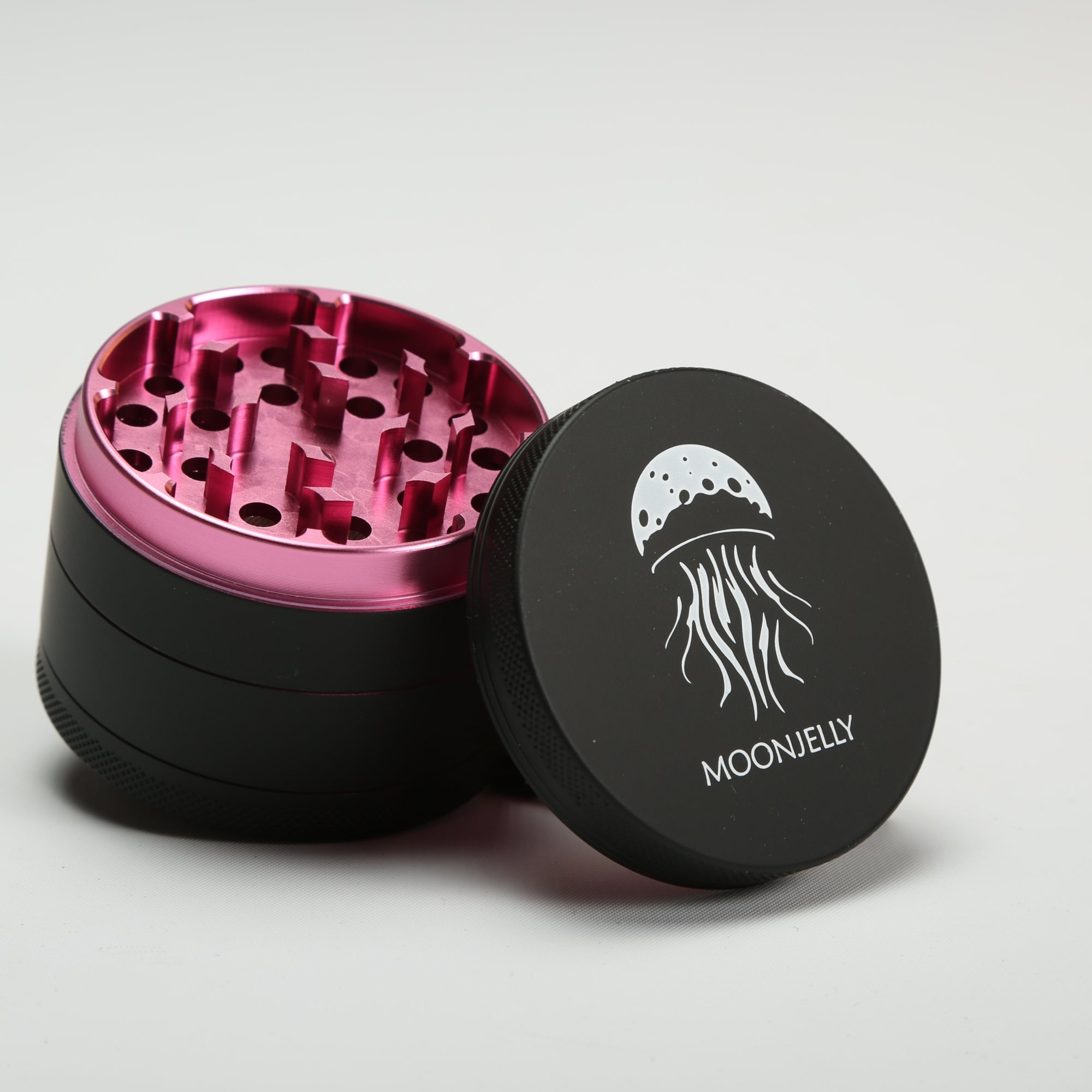 Black and pink herb grinder with &