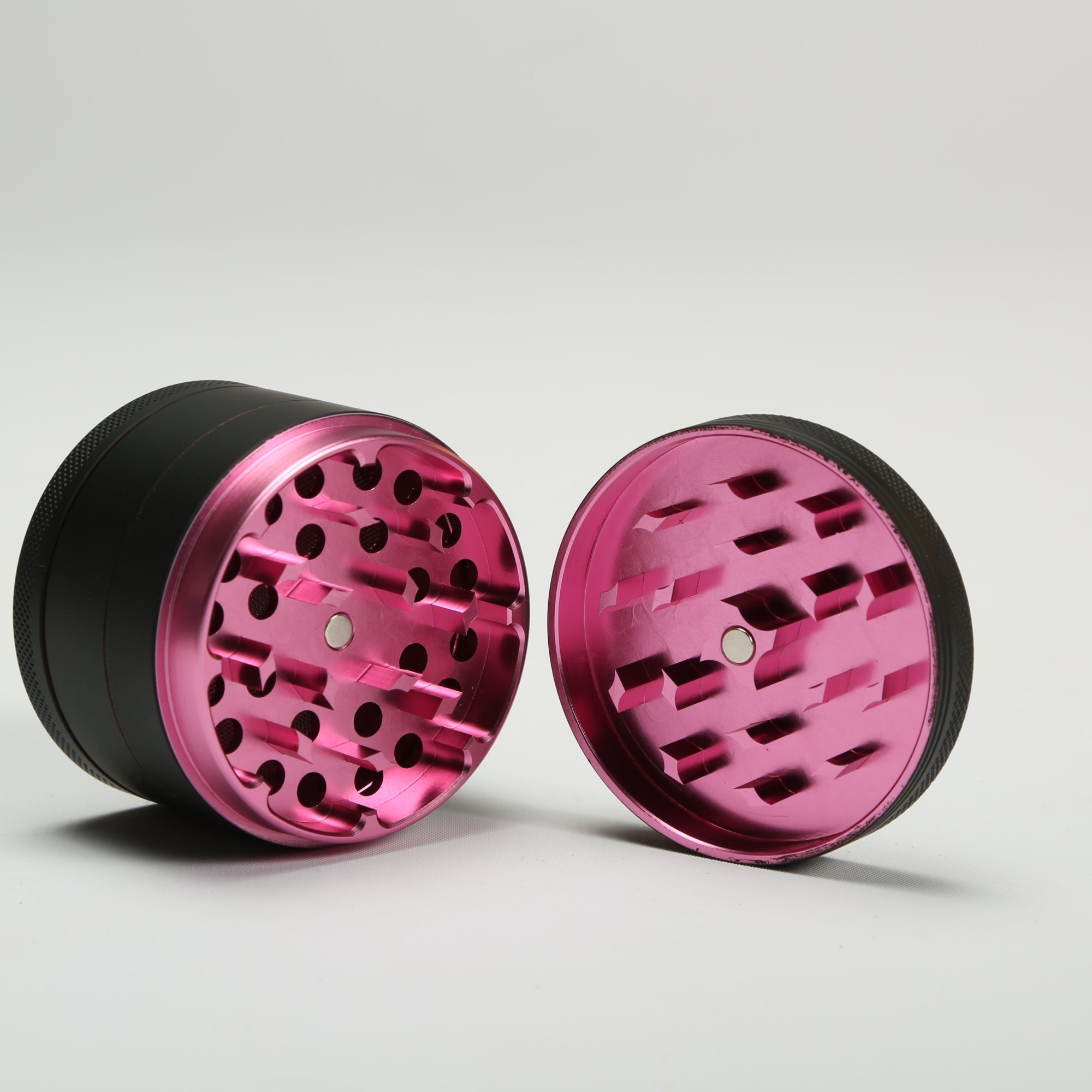 pink metal grinder on a light gray background