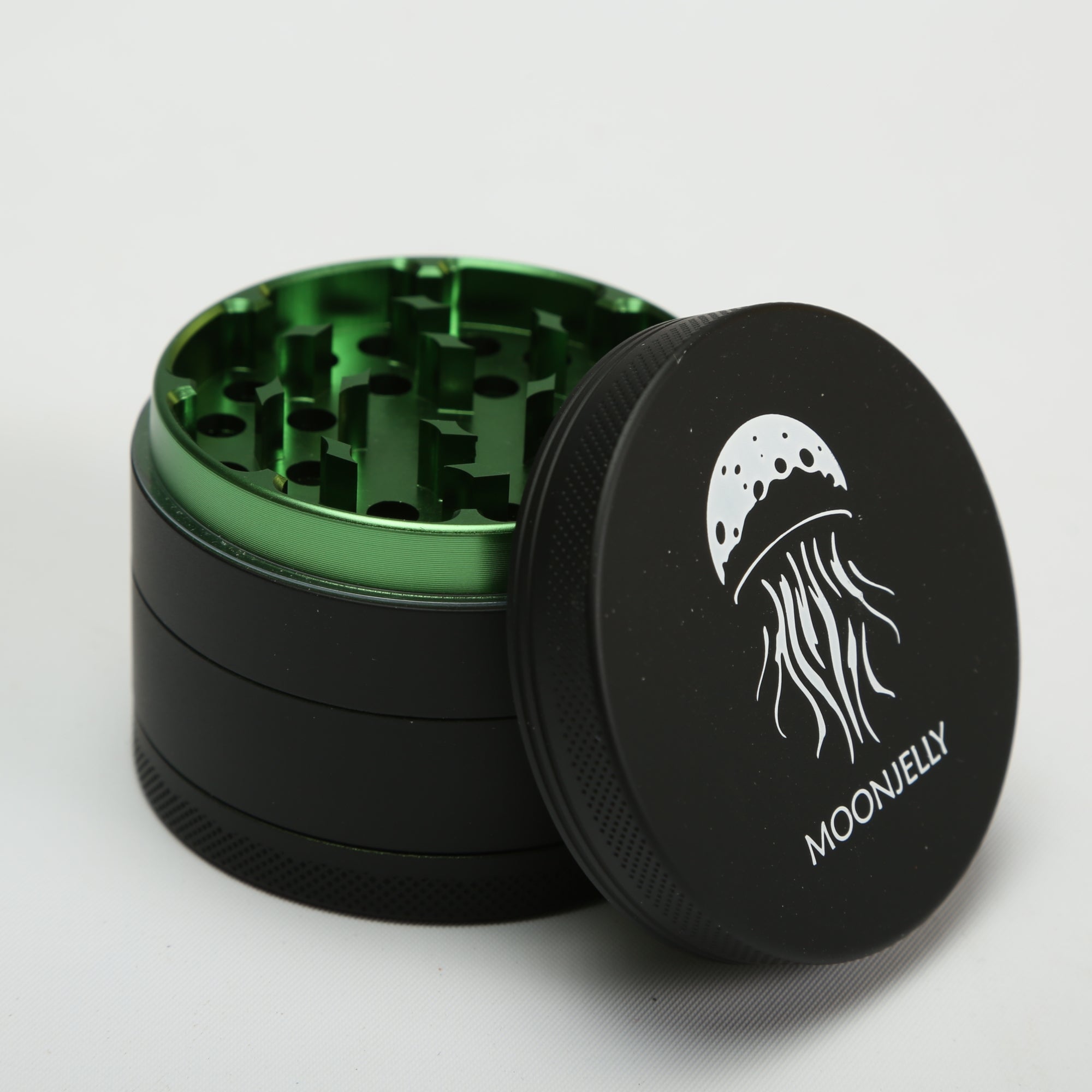 Black and green herb grinder with &