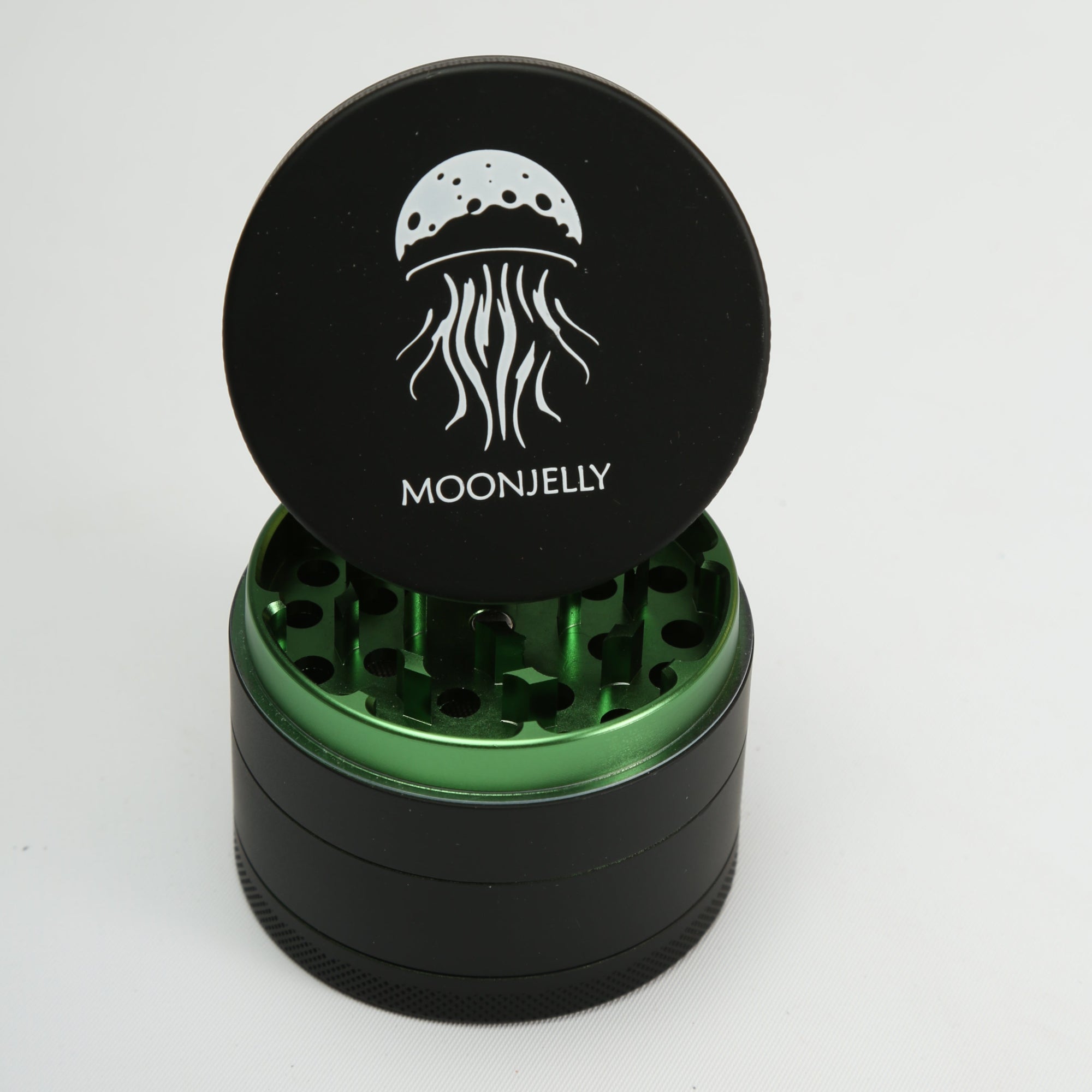 Black and green herb grinder with &