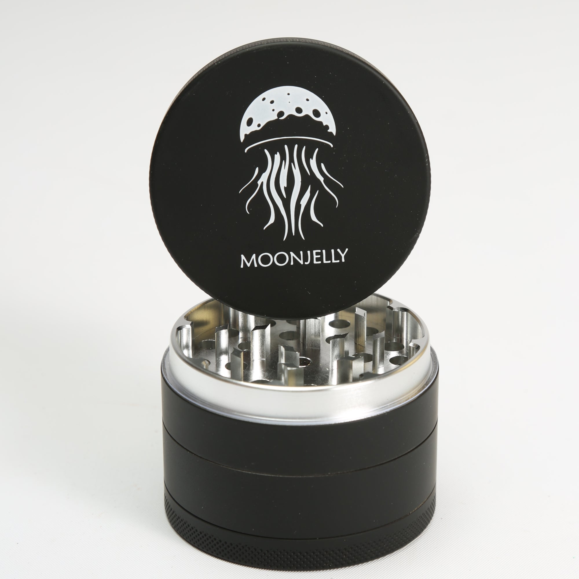 Black herb grinder with silver interior and &
