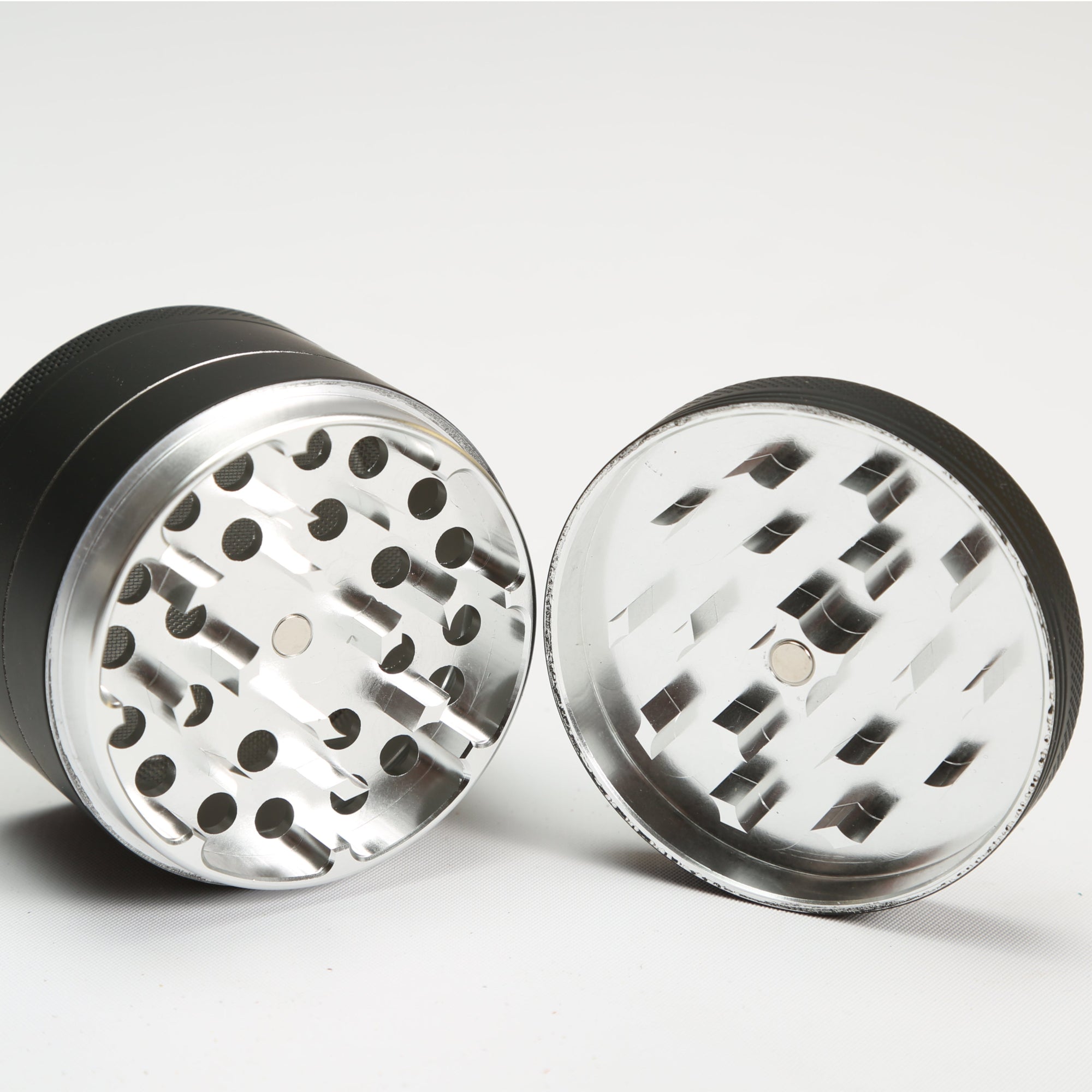 silver and black grinder on a white background