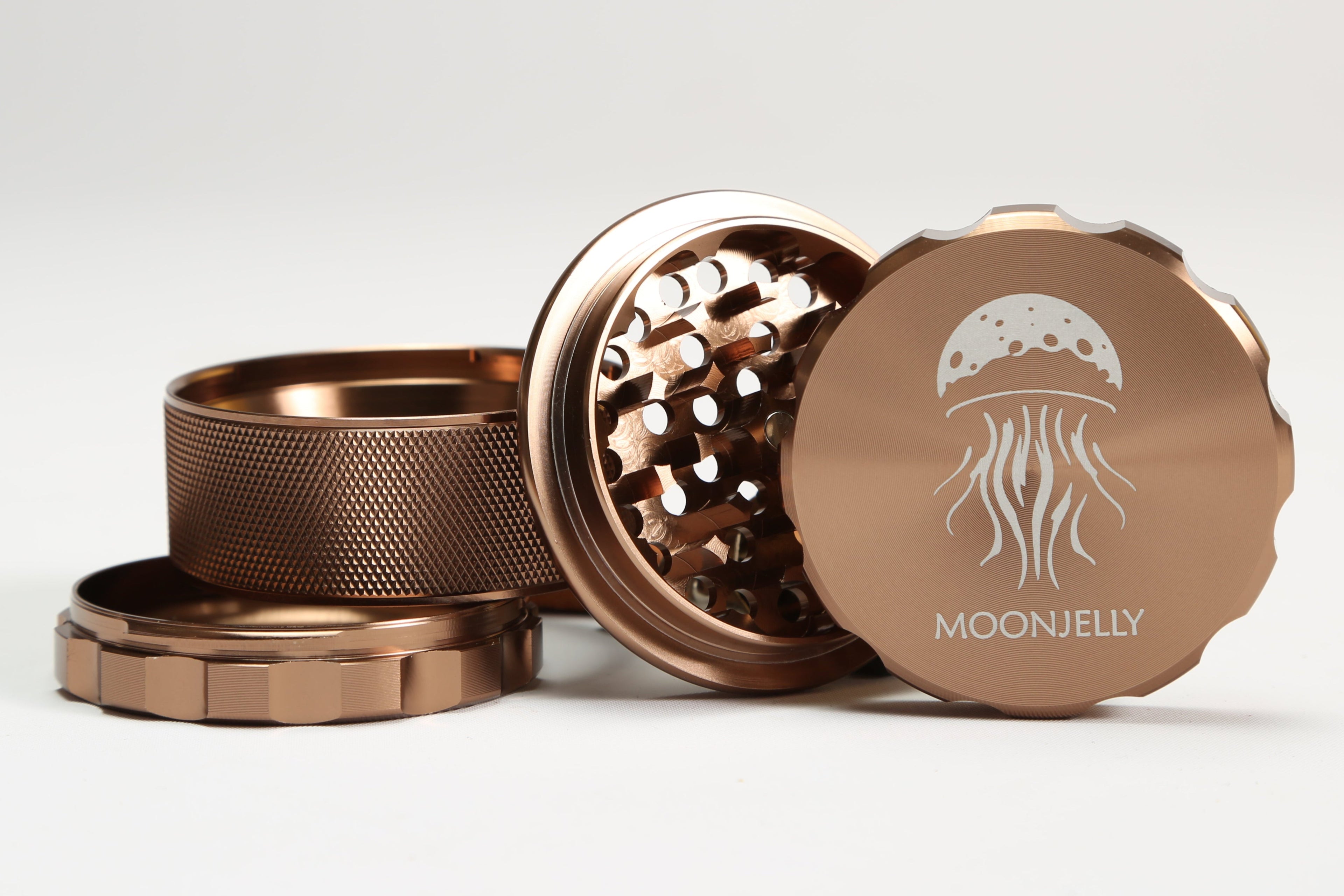 brown herb grinder with 'MoonJelly' logo on a white background