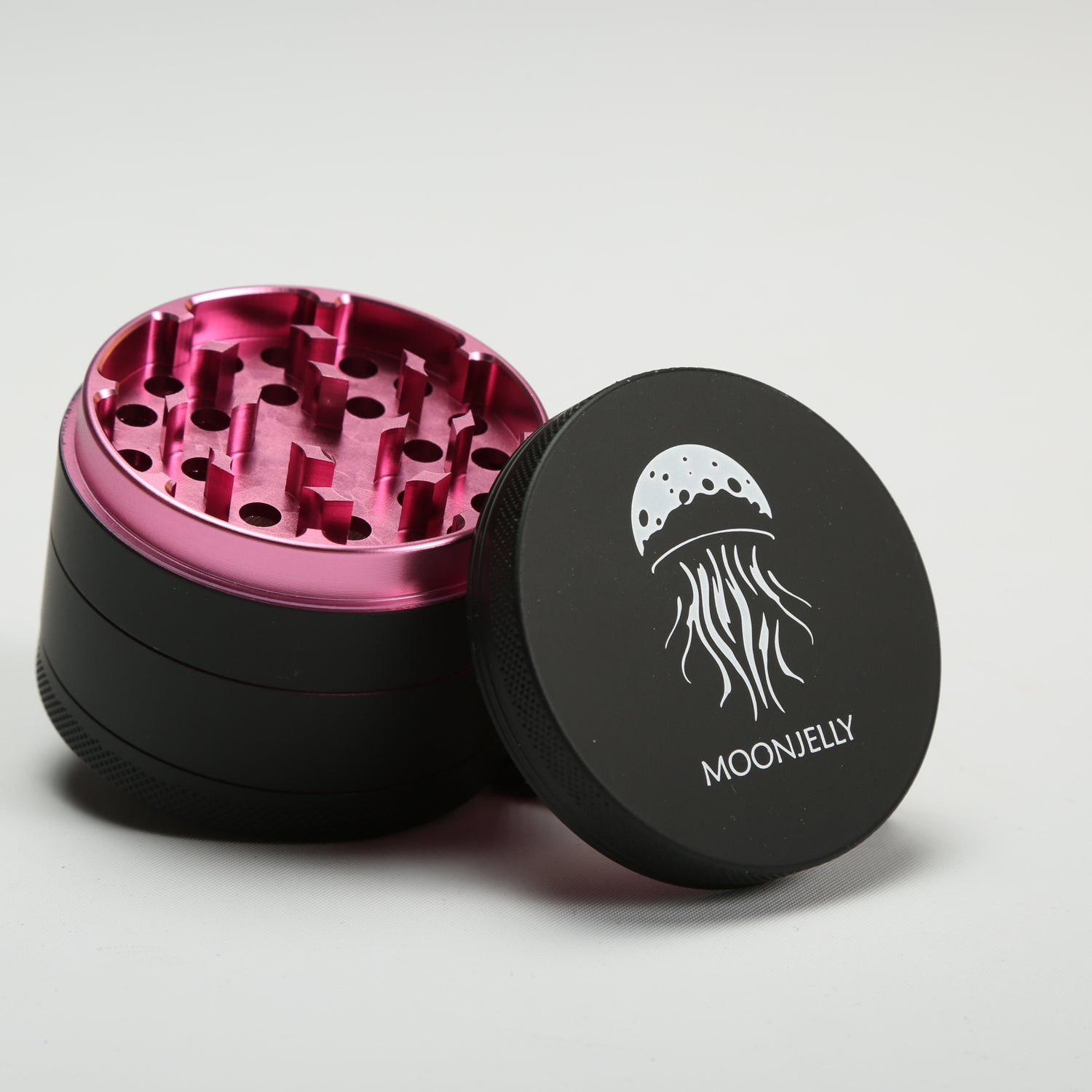 Black and pink herb grinder with &