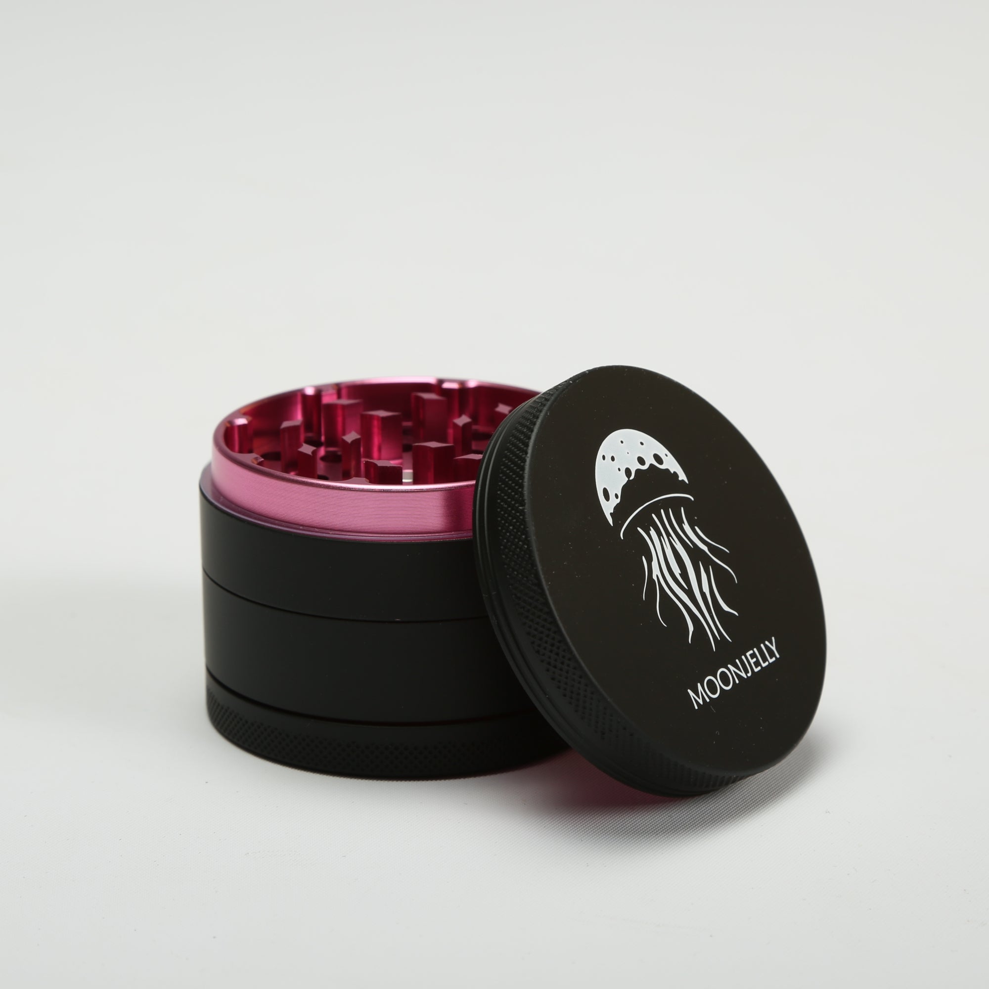 Black and pink herb grinder with &