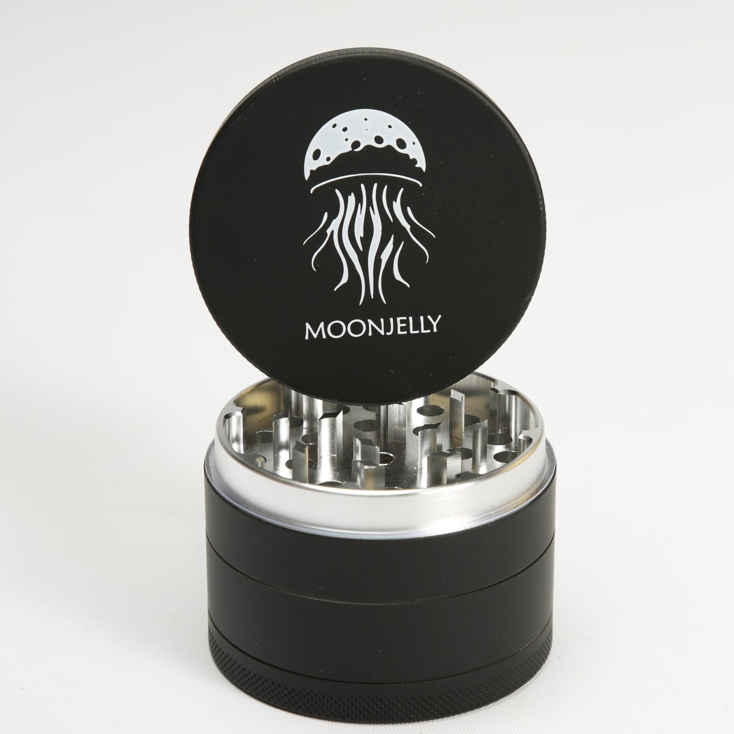 Black herb grinder with silver interior and &